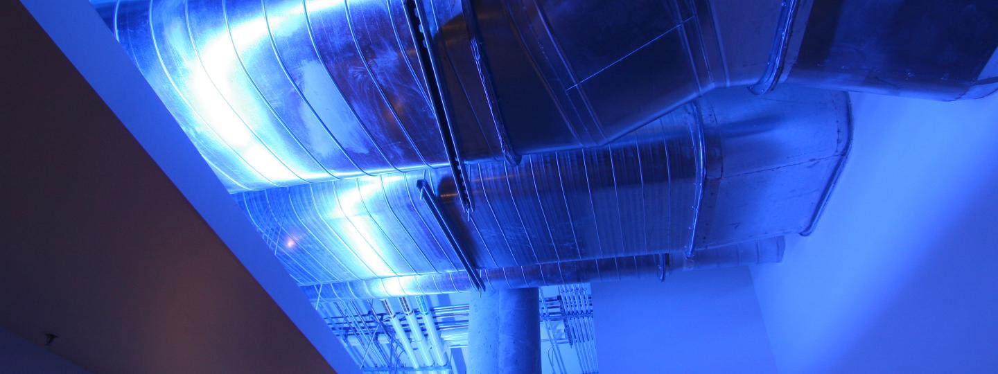 Air ducts on the ceiling of a hallway.